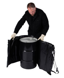 Man wrapping blanket heater around metal drum