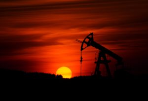 Oil rig with red sunset in background