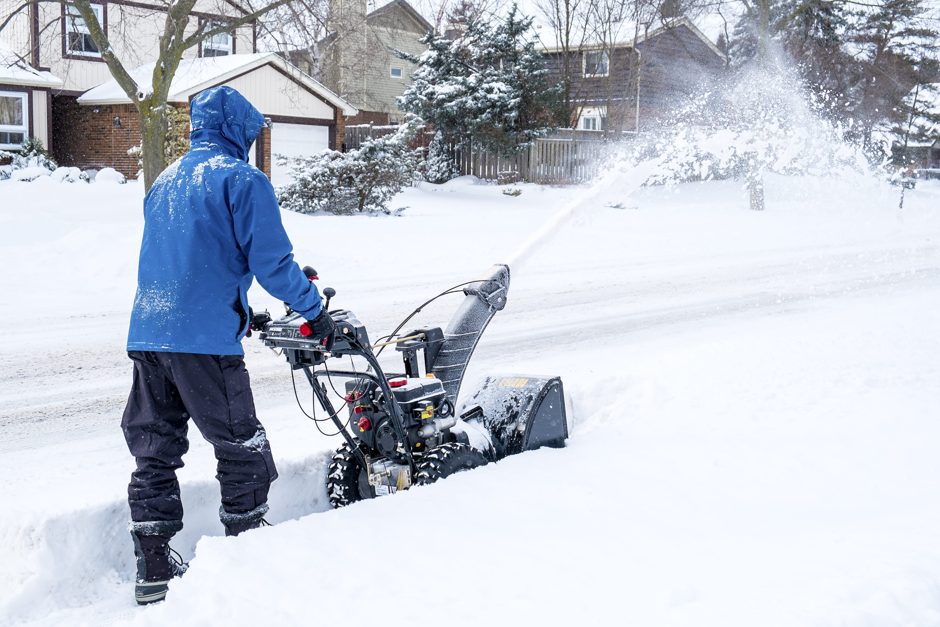 Man snow blowing sidewalk