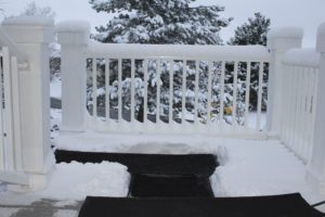 a snow covered porch with snow melting mats clearing the walkway