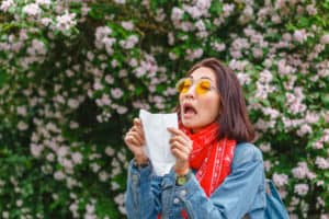Honey For Allergies with Brown Haired Woman Sneezing