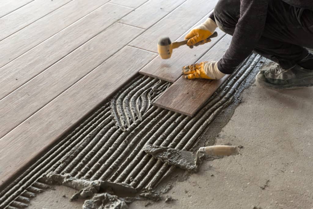 Worker laying mortar and tile